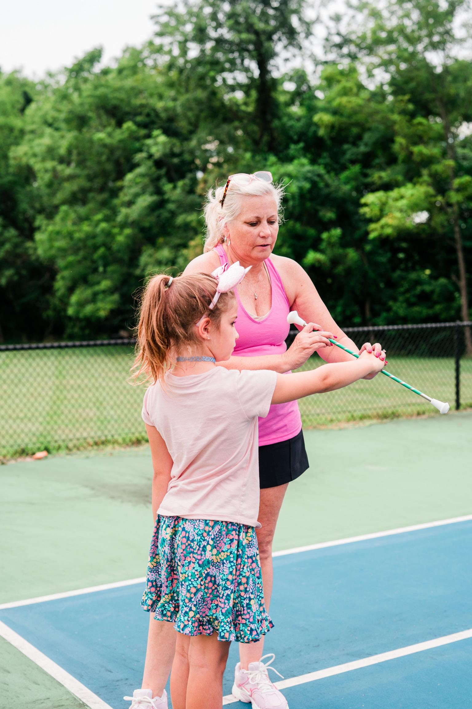 Staci teaching a student baton twirling technique