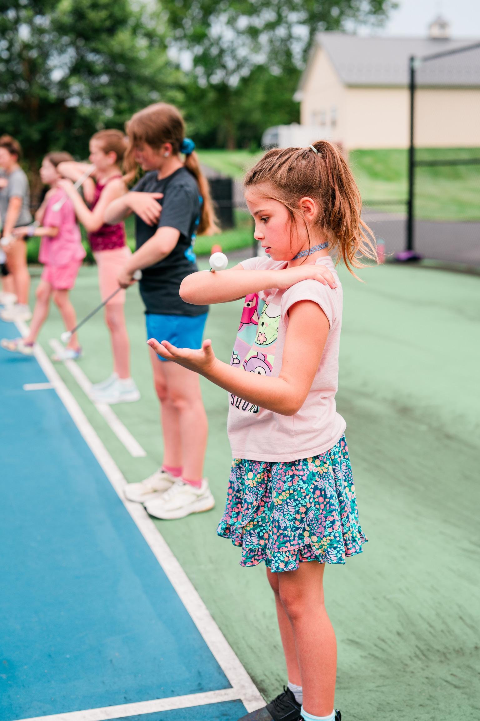 Young girl focused on baton twirling drill